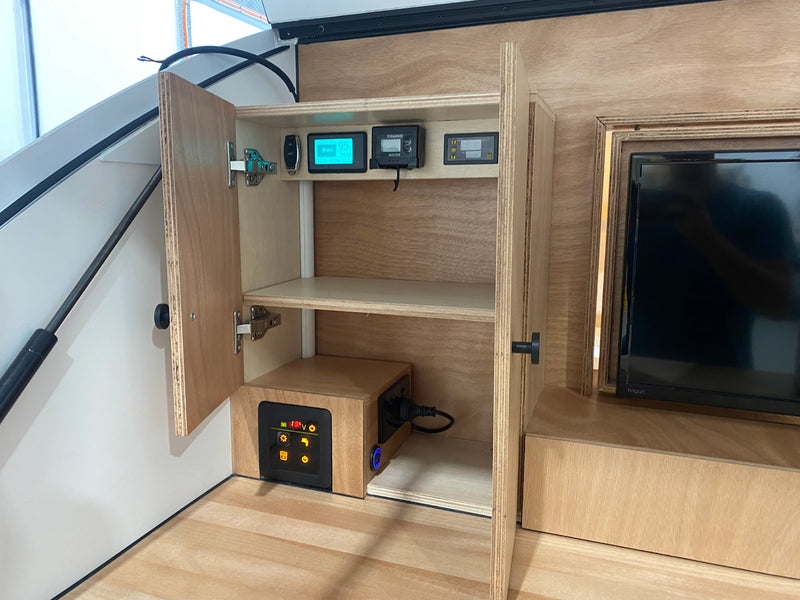 Topargee Surface Mount water tank gauge and additional monitoring gauges installed in a custom caravan control panel cabinet